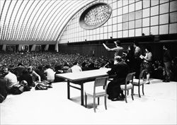 Giubileo del 1975: la domenica delle palme, pellegrinaggio dei giovani di CL a Roma, per l'incontro con Paolo VI. Don Giussani è sul palco dell'aula Nervi durante i canti (archivio CL).