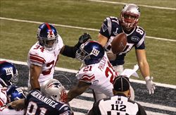 Nella copertina e in queste foto: alcuni momenti dell'incontro di football tra i Giants di New York e i Patriots di Boston nello stadio di Indianapolis (foto Reuters).