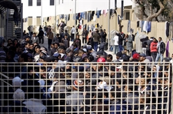 Profughi accompagnati nel centro di accoglienza a Lampedusa.