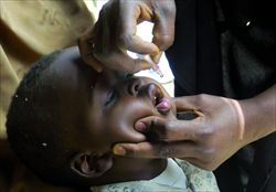 Personale Unicef somministra il vaccino antipolio a un bambino.