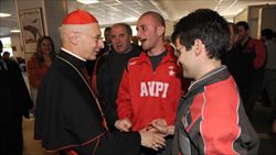 Il cardinale Bagnasco con alcuni lavoratori dell'Ansaldo Energia di Genova (foto Ansa).
